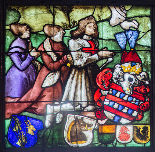 In addition to the two large coats of arms of his two wives and the ornate coat of arms of Blumeneck, the window depicts three coats of arms of his brothers-in-law.